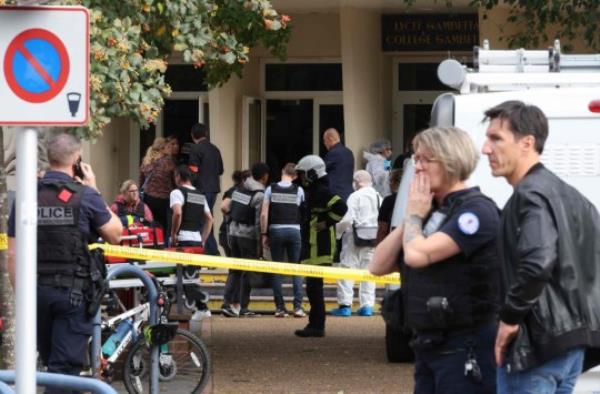 French police officers from the forensic service stand in front of the Gambetta high school in Arras, northeastern France on October 13, 2023, after a teacher was killed and two other people severely wounded in a knife attack, police and regio<em></em>nal officials said. The perpetrator has been detained by police, Interior Minister Gerald Darmanin wrote on X, formerly Twitter. (Photo by Denis CHARLET / AFP) (Photo by DENIS CHARLET/AFP via Getty Images)