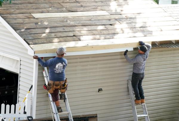 Workers replacing roof of home