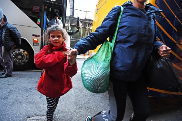 A bus of migrants arriving at the shelter at the Roosevelt Hotel on Dec. 21, 2023.