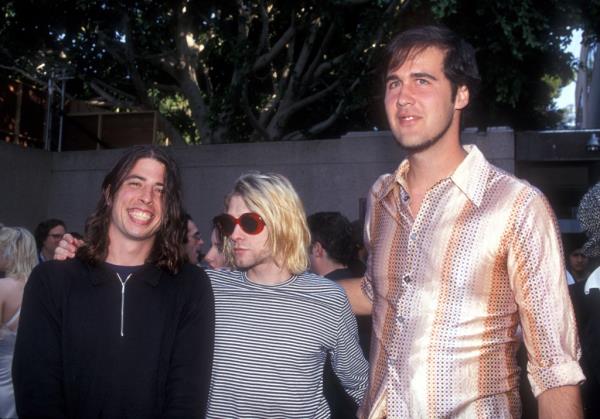 Dave Grohl, Kurt Cobain and Krist Novoselic of Nirvana pose for a photo. The suit says the image violated federal laws on child sexual abuse material.