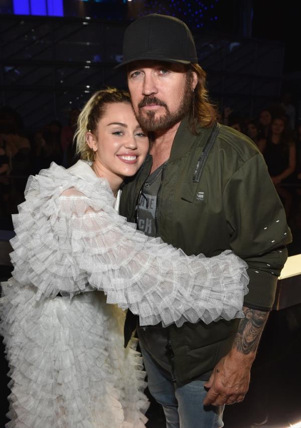 “Miley and Billy Ray are on the outs,” the source told US Weekly. “Miley’s very close with her mom and is standing by her.”