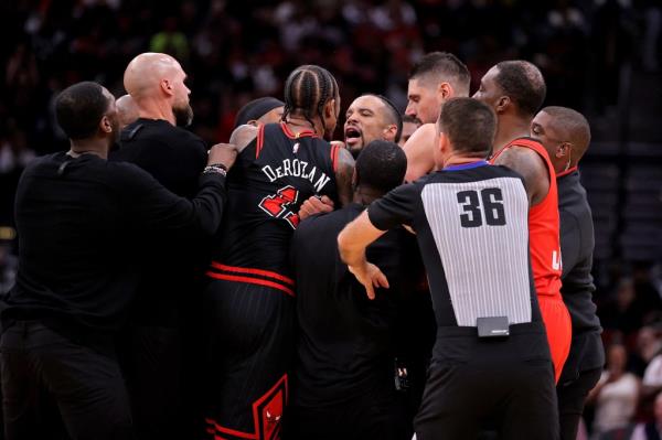 Chicago Bulls forward DeMar DeRozan and Houston Rockets forward Dillon Brooks being separated by game officials at Toyota Center, Houston, Texas