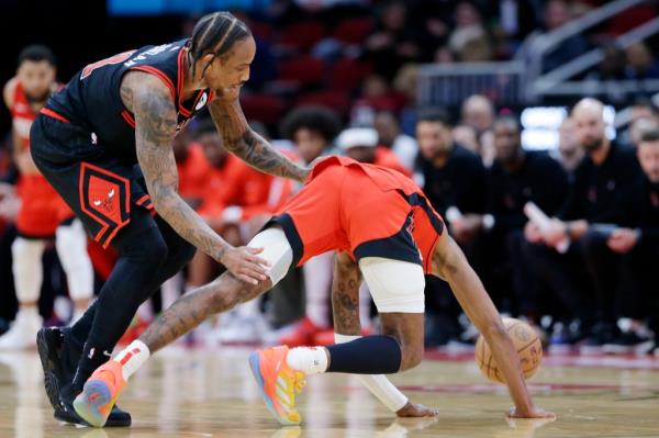 Houston Rockets guard Jalen Green falling to the ground after a flagrant foul by Chicago Bulls forward DeMar DeRozan, sparking a scuffle during an NBA basketball game