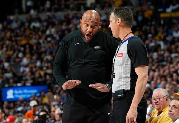 Los Angeles Lakers head coach Darvin Ham, left, argues for a call with referee Kevin Scott, front right, in the first half of Game 5 of an NBA basketball first-round playoff series against the Denver Nuggets, Monday, April 29, 2024, in Denver.