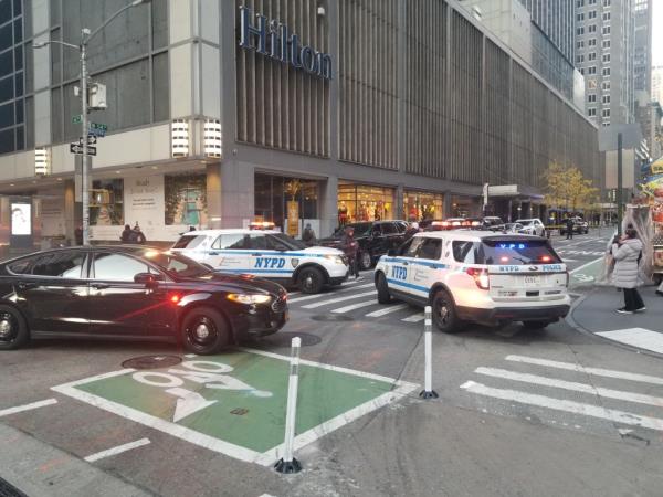 Police at the scene of the shooting outside a Hilton hotel in Midtown.