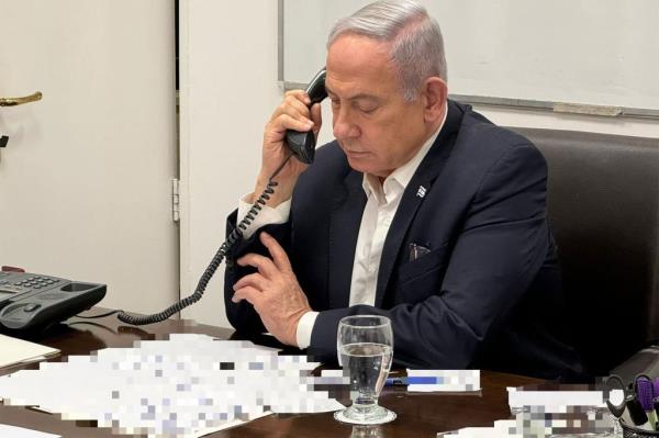 In this handout photo, released early Sunday local time, Israeli Prime Minister Benjamin Netanyahu talks on the phone with US President Joe Biden.