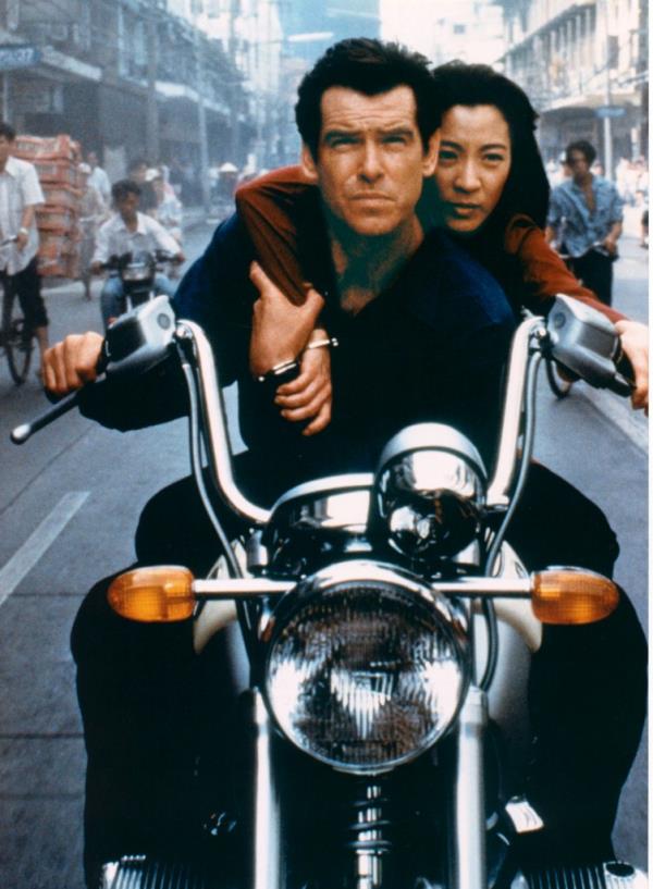 Pierce Brosnan as James Bond and Michelle Yeoh as Wai Lin, riding a motorcycle in a scene from the 1997 film, Tomorrow Never Dies.