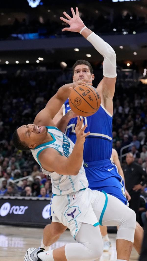 Charlotte Hornets forward Grant Williams (2) reacts after running into Milwaukee Bucks center Brook Lopez (11) in the second half at Fiserv Forum. 