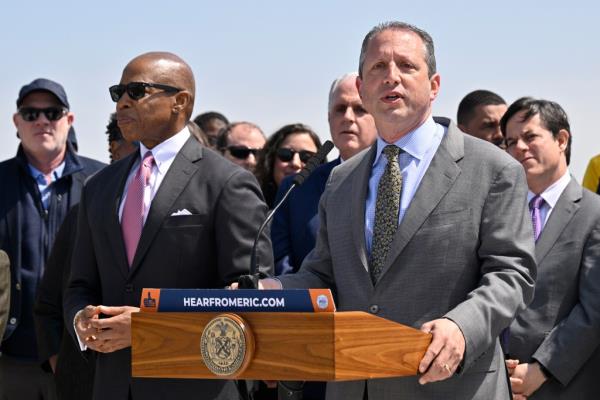 NYC Mayor Eric Adams and Comptroller Brad Lander standing behind a podium