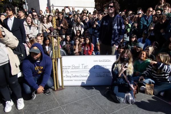 Co<em></em>ntest participants and spectators posing for a photo with the prize in Washington Square Park.