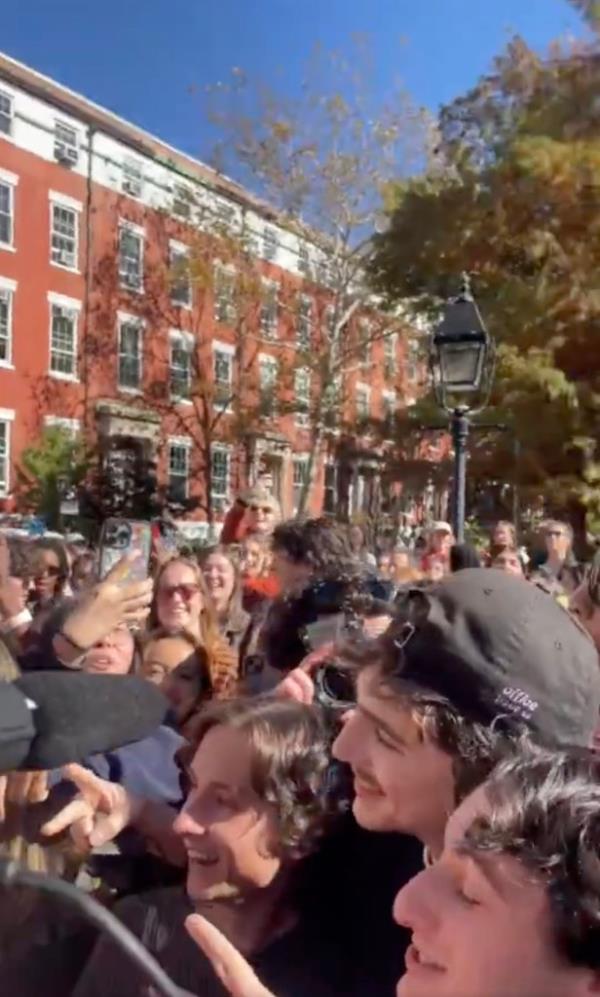 The real Chalamet taking photos with fans.