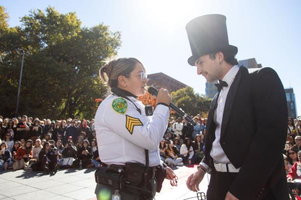 A Parks Enforcement officer taking Po's microphone away.