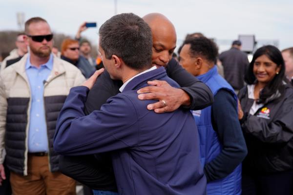 Maryland Gov. Wes Moore embracing Buttigieg after a news co<em></em>nference on the collapse.