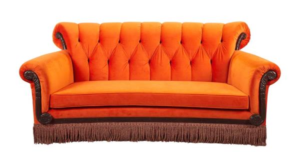 A photo of a replica orange couch .