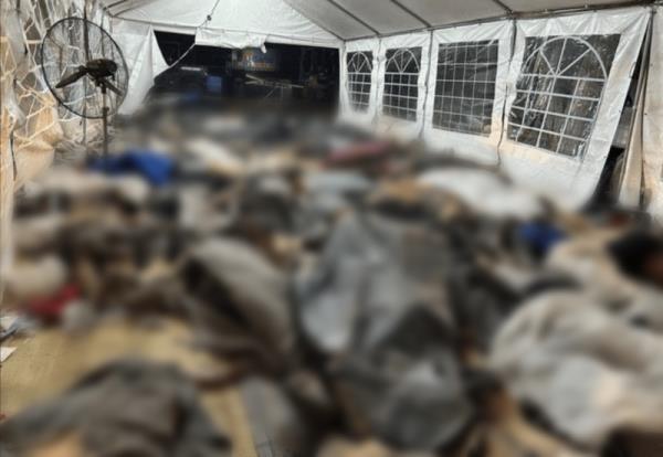 Scores of bodies were placed under a tent as officials collected the remains of 346 people at the Nova festival.