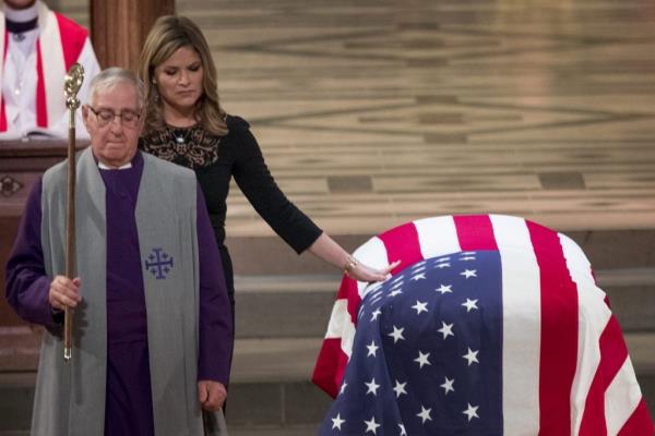 Jenna Bush Hager touching the flag-draped casket of former President George H.W. Bush at his State Funeral in the Washington Natio<em></em>nal Cathedral