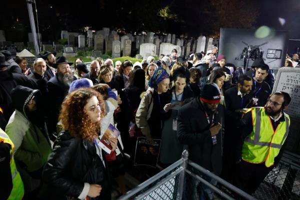 Family members wait outside to get into the tomb of the Rebbe. 