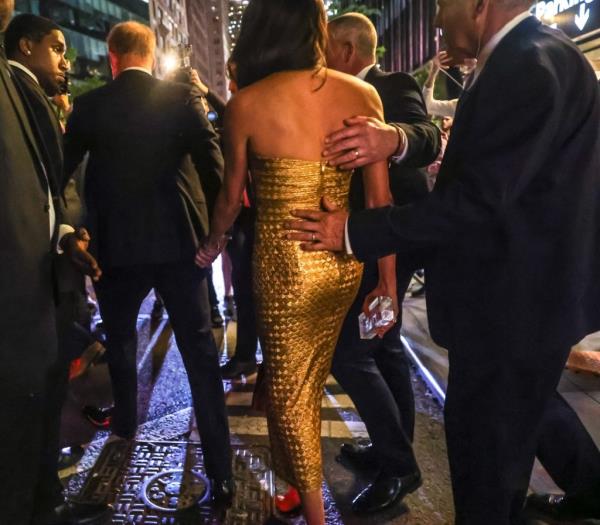 Meghan Markle in gold dress receiving Women of Vision award from Gloria Steinem, with Prince Harry at Ziegfeld Ballroom, New York City