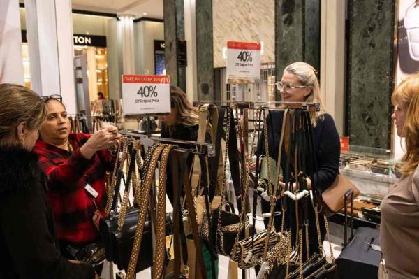 People shop for purses at Macy's on Black Friday on Nov. 24, 2023.