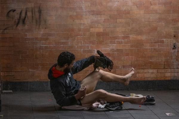 A man attempts to clean feces from his body