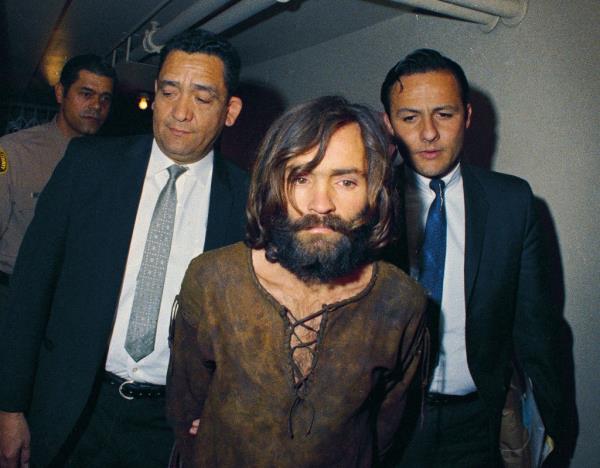 Charles Manson is escorted to his arraignment on conspiracy-murder charges in co<em></em>nnection with the Sharon Tate murder case in 1969. 