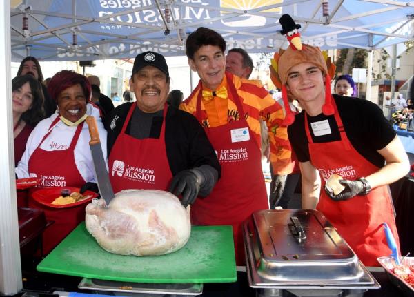 Danny Trejo (second from left), BJ Korros and Alexander James Rodriguez at Los Angeles Mission's Annual Thanksgiving Outreach on Skid Row, California, on Nov. 27, 2024. 