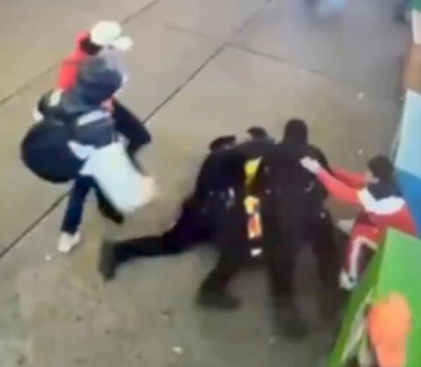 Surveillance video captures the migrants putting their hands on the police officers.