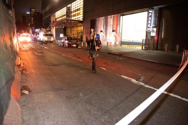 An Emergency Service Unit officer prepares to retrieve parts of the body at the Mandarin Hotel 