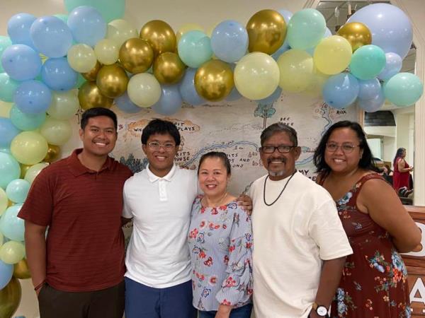 Noah Legaspi (left, glasses) and family in 2022.