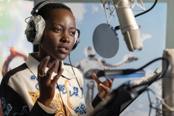 Actress Lupita Nyong'o seen speaking into a microphone as she performs the voice for her character in animated movie, 