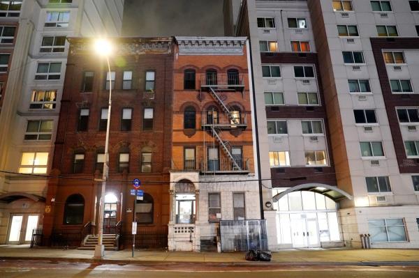 A general view of apartment buildings lit up at night as seen on E163rd Street in the Bronx, NY on April 24, 2024.