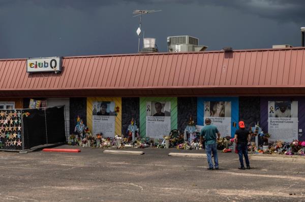 People visit a memorial outside Club Q