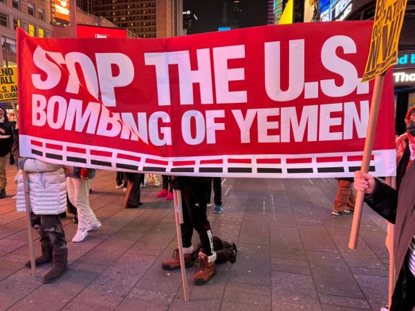 Pro-Yemen supporters holding a sign reading, 