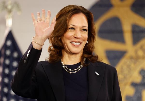 Kamala Harris waves as she arrives to speak during a campaign rally at United Auto Workers Local 900 in Wayne, Michigan, August 8, 2024. 