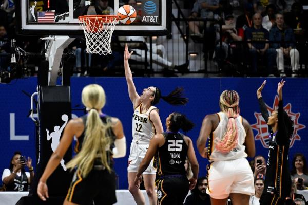 Indiana Fever guard Caitlin Clark (22) scoring her first WNBA career basket against Co<em></em>nnecticut Sun during a basketball game