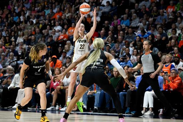 Indiana Fever guard Caitlin Clark (22) puts up a 3-point shot to score against the Co<em></em>nnecticut Sun during the fourth quarter of a WNBA basketball game, Tuesday, May 14, 2024, in Uncasville, Conn.