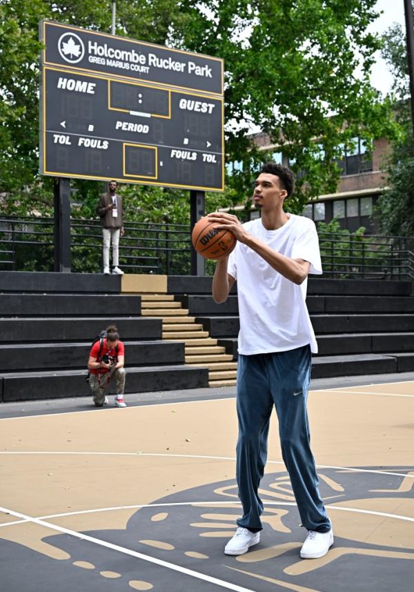 Victor Wembanyama shoots a basket during his visit to Rucker Park on June 21.