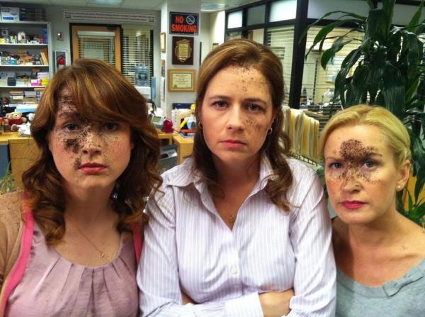 Ellie Kemper, Jenna Fischer, Angela Kinsey with dirt on their faces looking serious. 