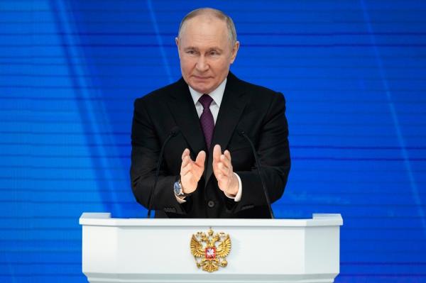 Vladimir Putin speaking at a podium in Moscow.