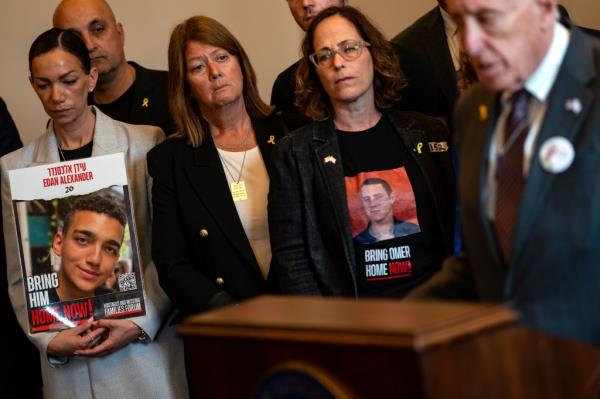 Yael Alexander, left, and Orna Neutra, center, attend a news co<em></em>nference in Washington last mo<em></em>nth a<em></em>bout the efforts to free their sons.