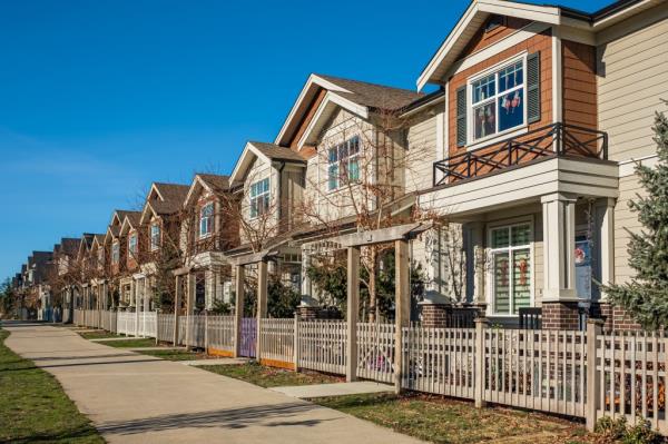 Modern residential houses neighborhood street with green plants in a suburban residential area