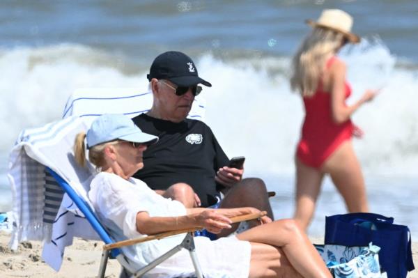 US President Joe Biden and First Lady Jill Biden sitting in chairs on the beach in Rehoboth Beach, Delaware