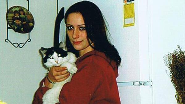 Woman holding a cat, representing Brianna Maitland who vanished twenty years ago from Montgomery, Vermont, with a background note of a $40,000 FBI reward for information.