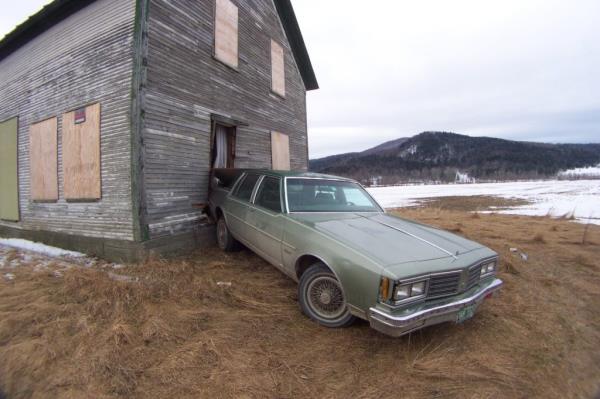 Abando<em></em>ned car crashed backwards into a deserted farmhouse near Route 118, referencing the unsolved case of Brianna Maitland's disappearance.