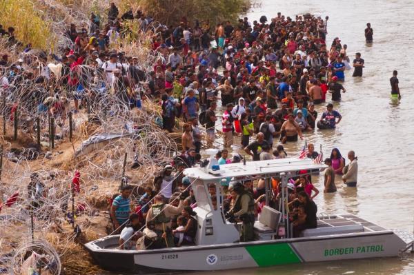 Migrants who crossed the Rio Grande river from Mexico into the United States are transported by U.S. Customs and Border Protection officers by boat for processing on Monday, September 25, 2023 in Eagle Pass, Texas.