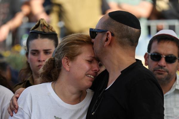 Marciano's parents at her funeral crying. 