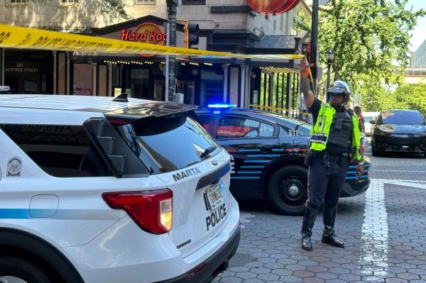 Police respond to the scene of a shooting outside the Peachtree Center complex.