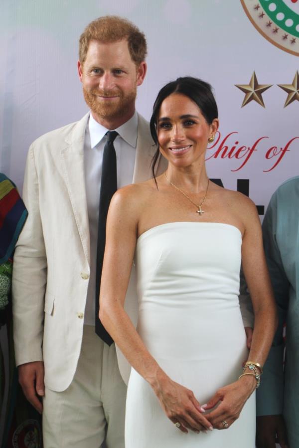 Prince Harry, Duke of Sussex, and Britain's Meghan, Duchess of Sussex, pose for a photo as they attend the program held in the Armed Forces Complex in Abuja, Nigeria on May 11, 2024. 