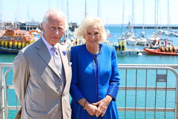 King Charles III and Britain's Queen Camilla pose for pictures during an official visit to Guernsey, on July 16, 2024.