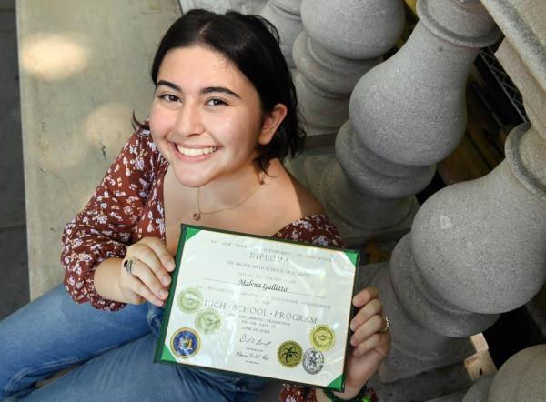 Malena Galletto poses with her graduation diploma from Bronx Science High School 